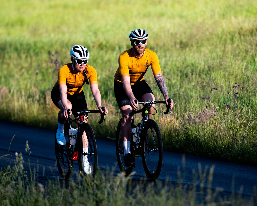 Cyclists wearing cycling jerseys in deep yellow by Sigr