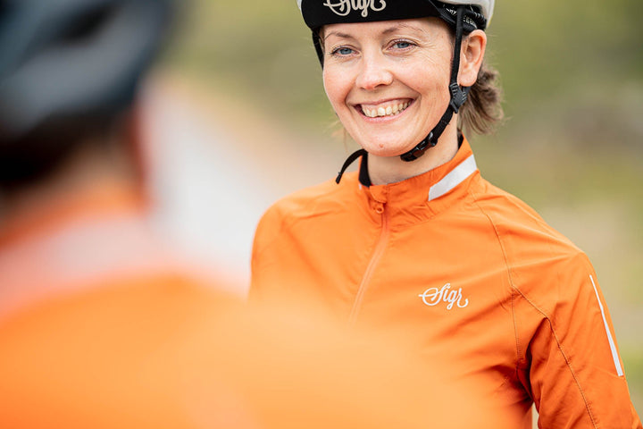 Treriksröset Orange Women's Cycling Wind/Pack Jacket by Sigr Cycling Clothing