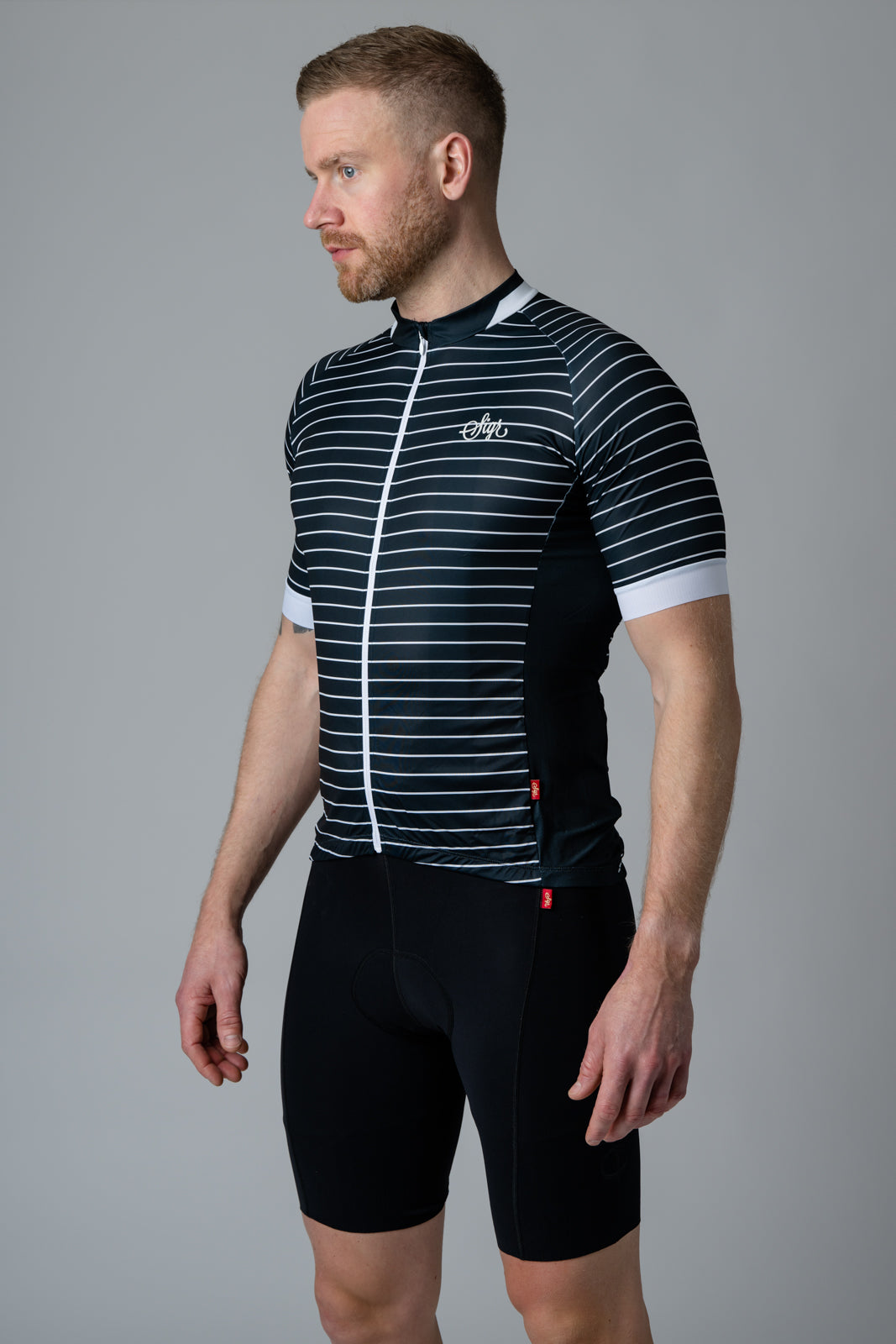Man modelling a black and white striped 'Black Horizon' cycling jersey